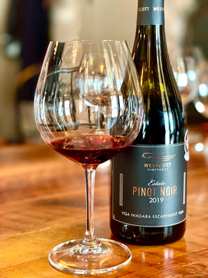 A bottle and glass of Westcott Vineyards 2019 Pinot Noir