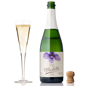 A bottle and glass of 2023 Violette Sparkling Brut