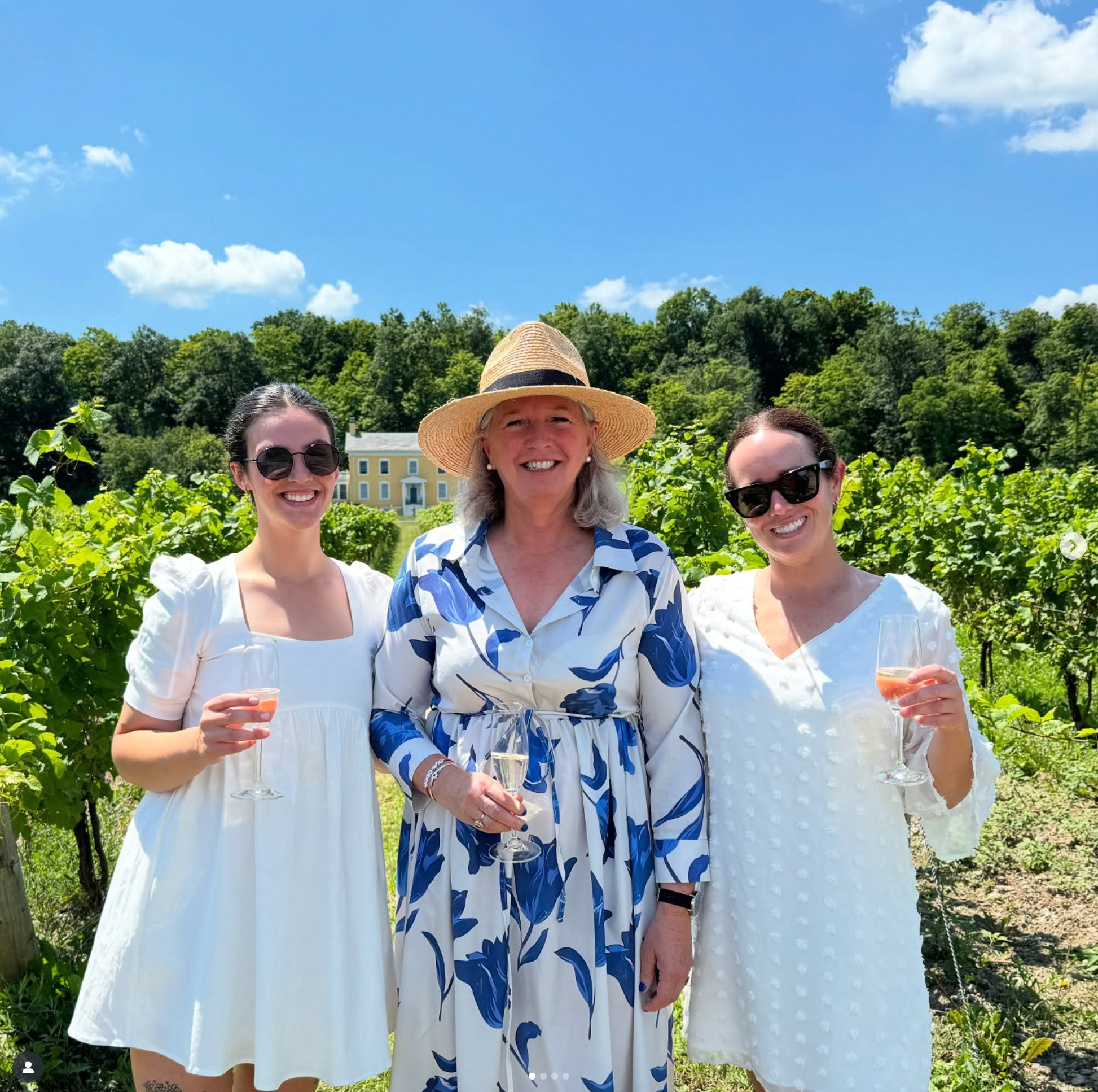 Owner Carolyn Hurst and Sales Director Jessica Ramage stand with a friend in the Butler's Grant vineyard. 