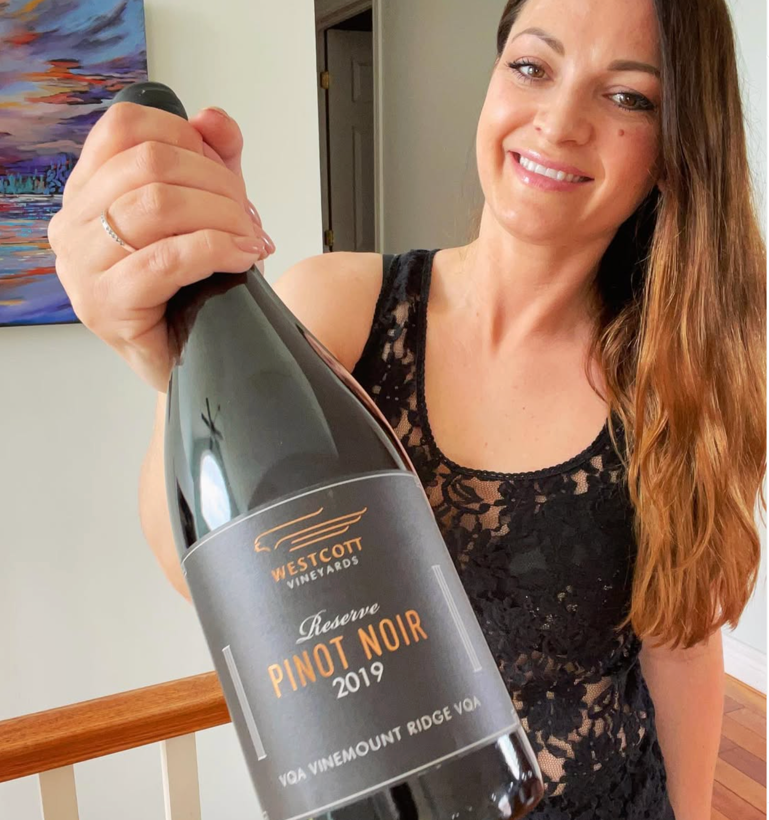 Wine critic Leah Spooner holds a bottle of Westcott Vineyards' 2019 Reserve Pinot Noir. 